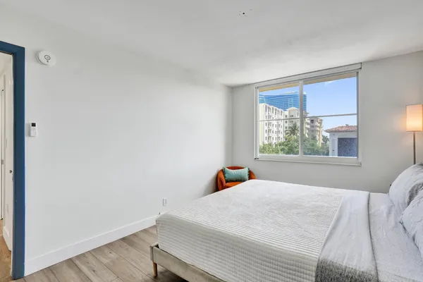 a bedroom with a bed and a window