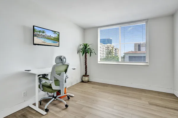 a view of a workspace with furniture and a window