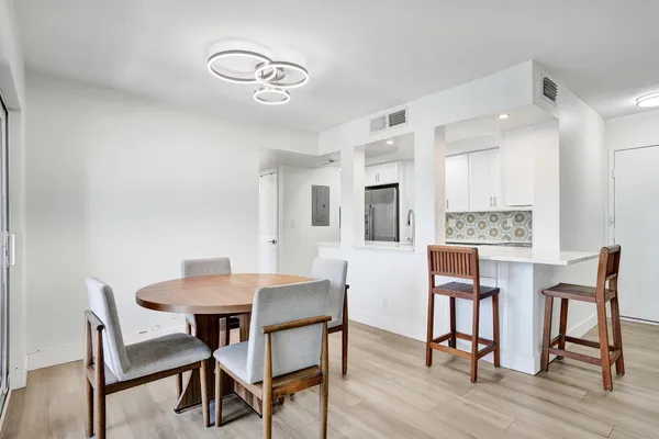 a view of a dining room with furniture and wooden floor