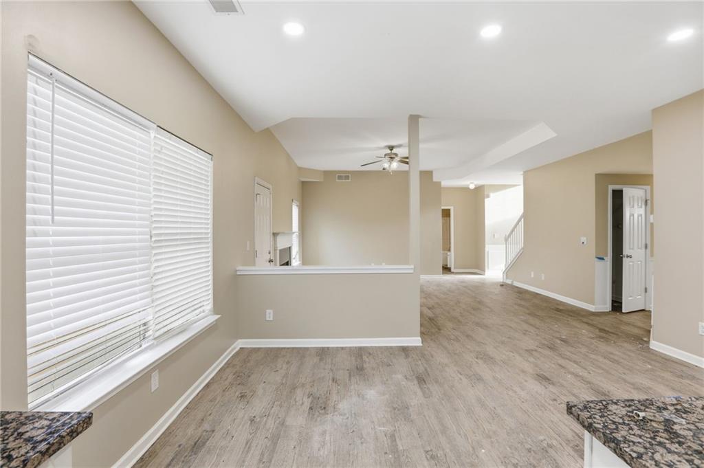 4968 Locherby Drive Fairburn, GA 30213 - Photo 7 of 39 a view of empty room with wooden floor and fan