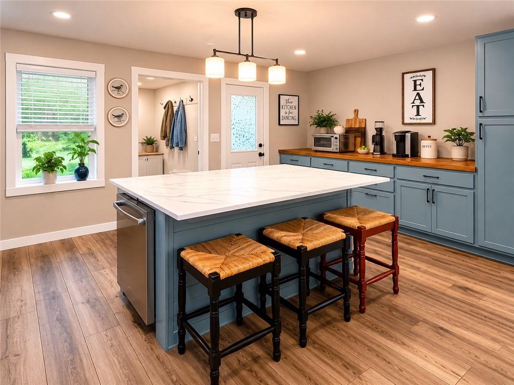 960 South Main Street Jasper, GA 30143 - Photo 3 of 12 a dining hall with stainless steel appliances granite countertop wooden floor a dining table and chairs