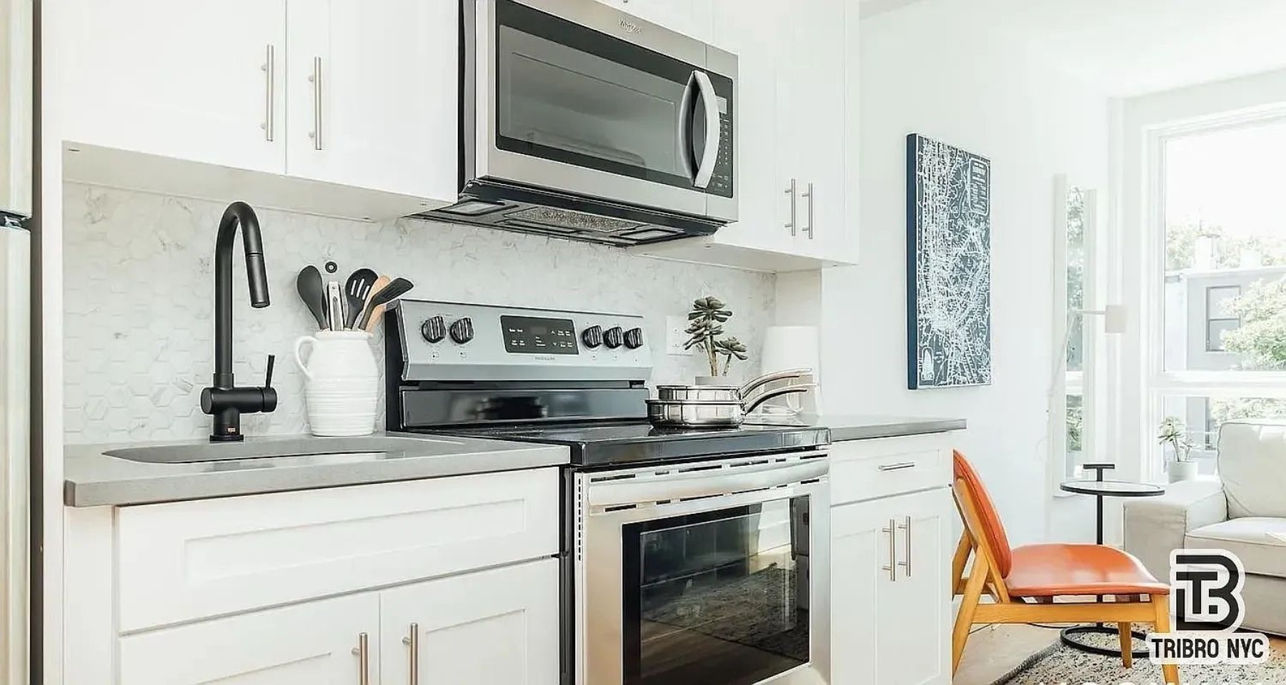 9 Cook Street, Unit 2F Brooklyn, NY 11206 - Photo 3 of 9 a kitchen with stainless steel appliances granite countertop a sink stove and microwave
