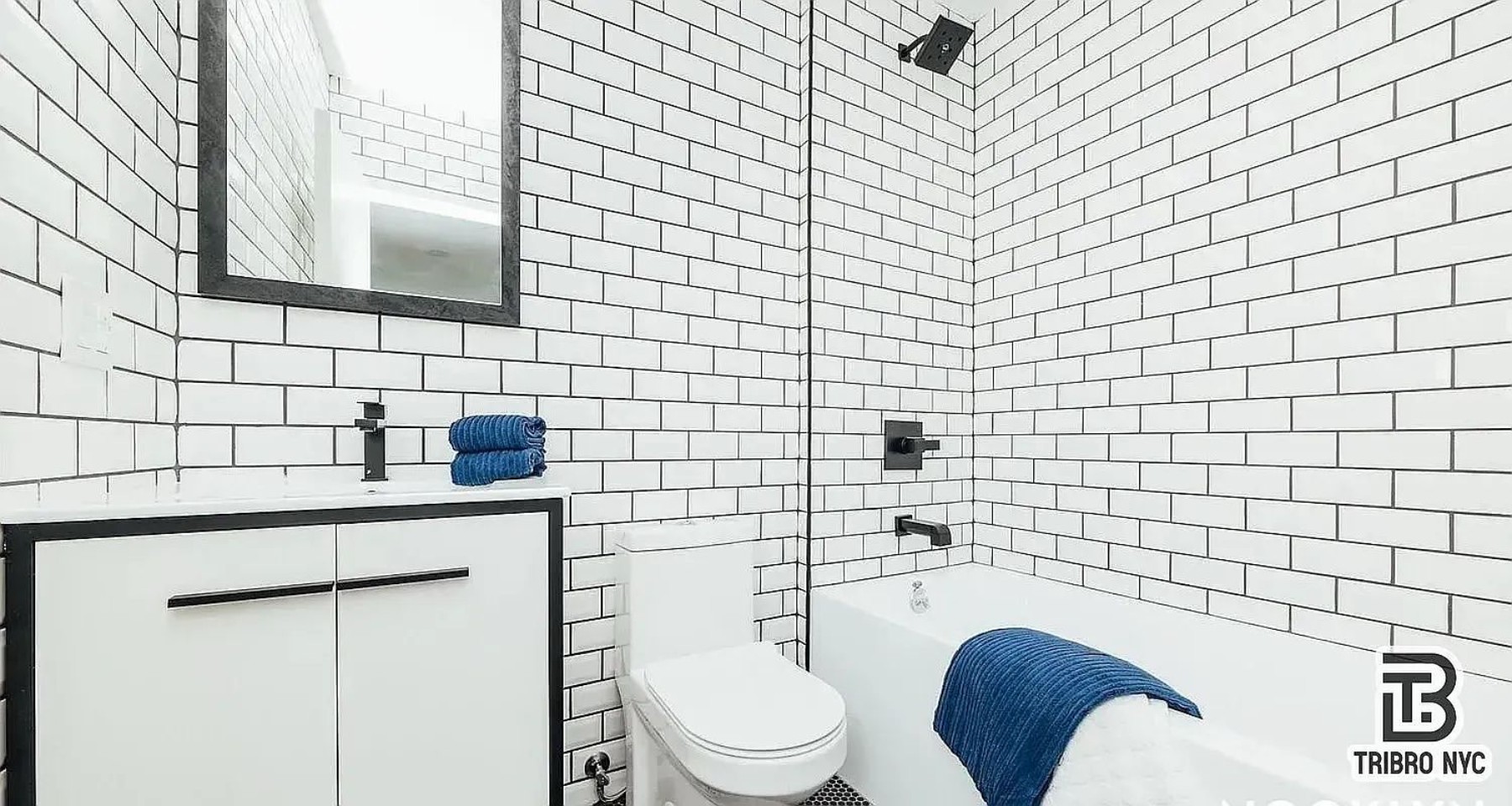 9 Cook Street, Unit 2F Brooklyn, NY 11206 - Photo 7 of 9 a bathroom with a toilet sink and mirror