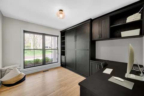 a view of workspace with wooden floor and windows