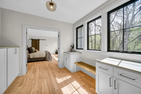 a bedroom with a bed and a large window