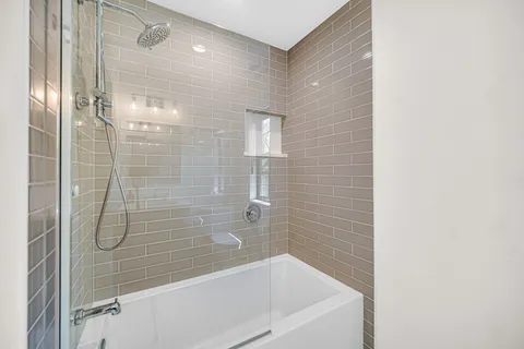 a bathroom with a shower and bathtub