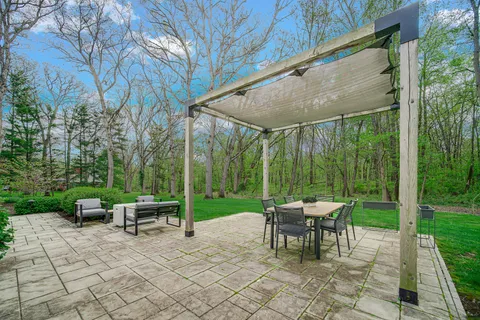 a view of a chair and tables in the backyard