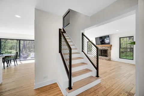 a view of entryway and hall with wooden floor