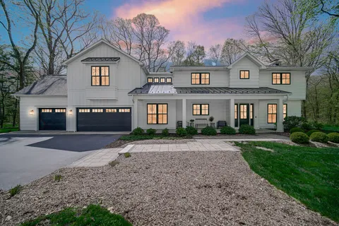 a front view of a house with a yard and a garage