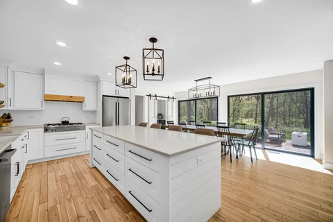 a large white kitchen with a large window