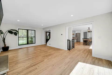 a view of a room with wooden floor and windows