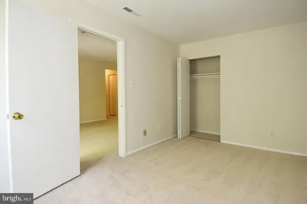 an empty room with closet area