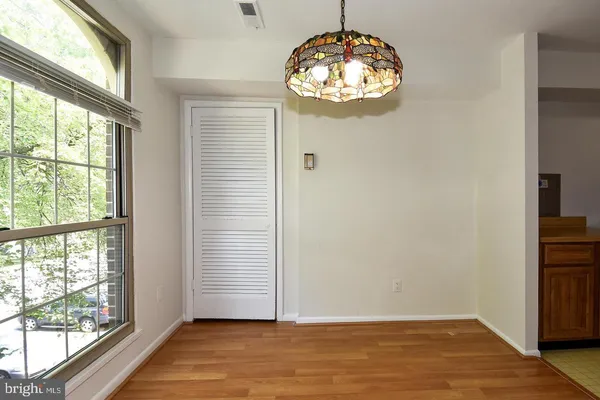 a view of wooden floor and a chandelier in a room