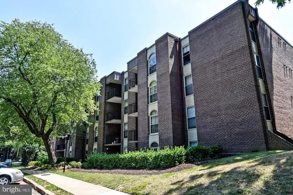 a view of a brick building next to a yard