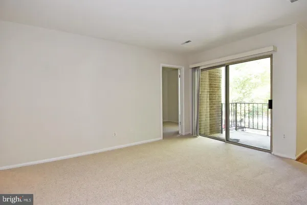 a view of an empty room with a balcony