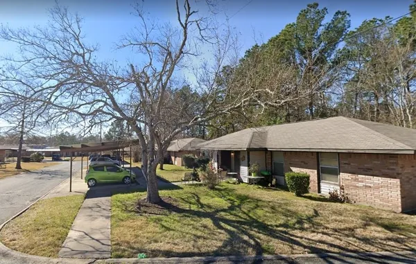 a view of a house with backyard porch and sitting area