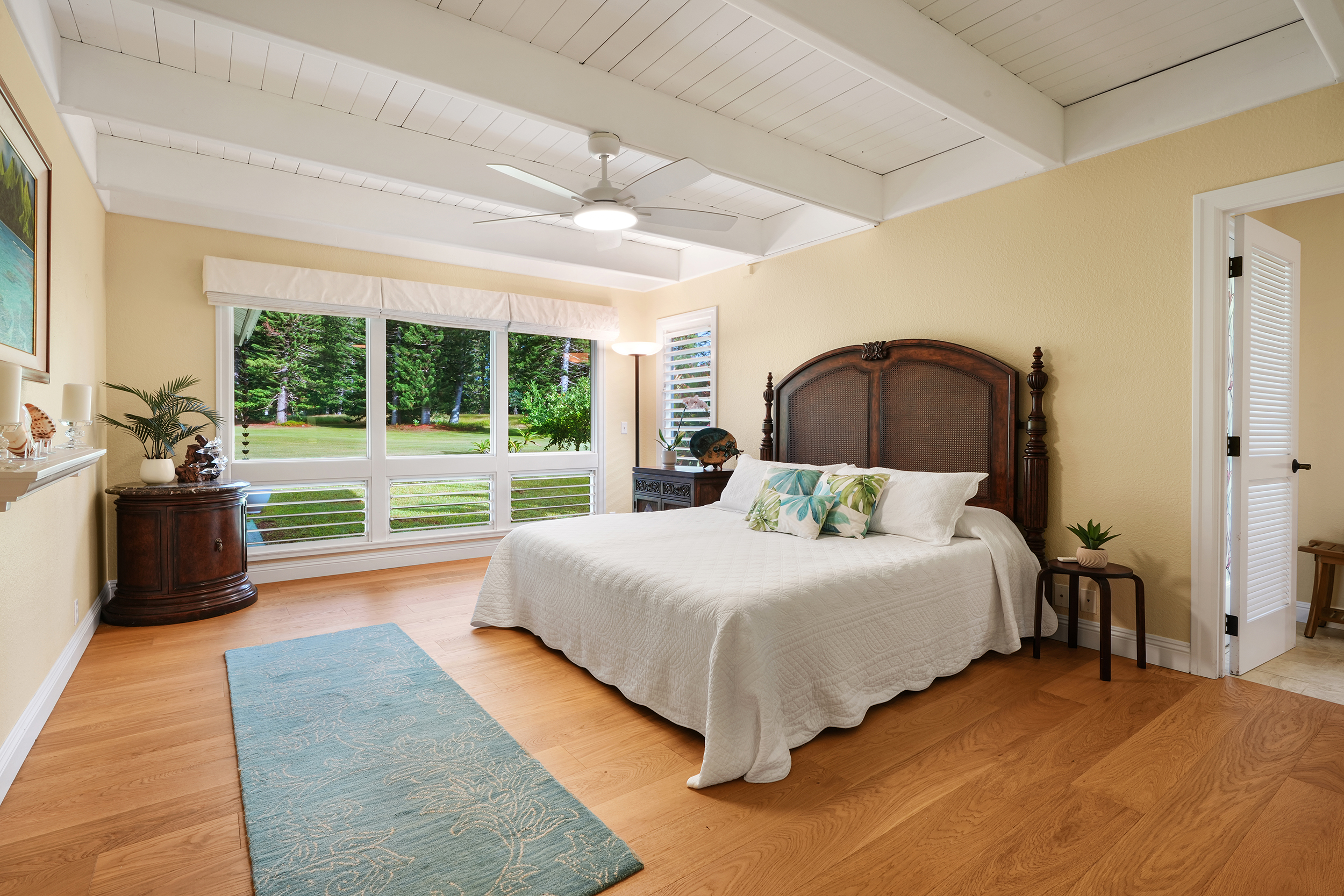 4165 Liholiho Road Princeville, HI 96722 - Photo 15 of 28 a bedroom with a bed lamp and large window