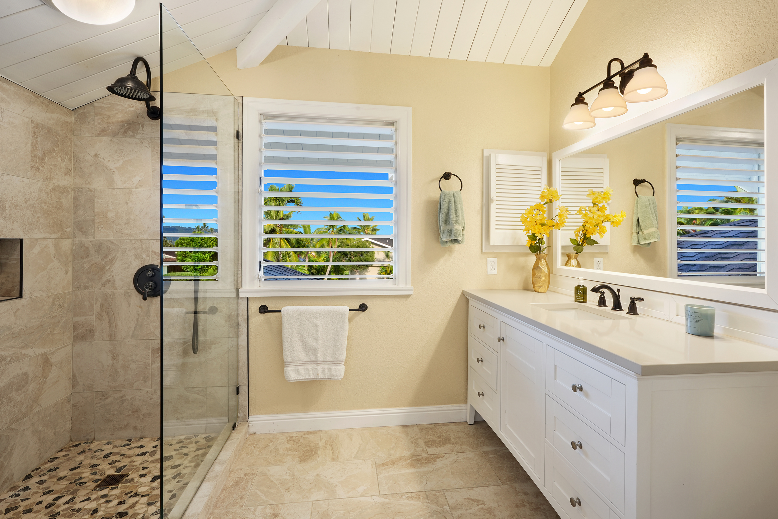 4165 Liholiho Road Princeville, HI 96722 - Photo 16 of 29 a bathroom with a granite countertop sink a mirror and a shower