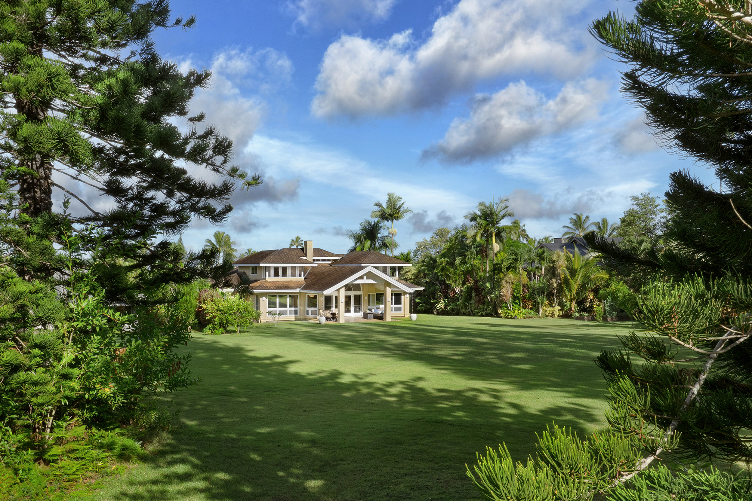 4165 Liholiho Road Princeville, HI 96722 - Photo 24 of 28 a view of a big house with a big yard and large trees