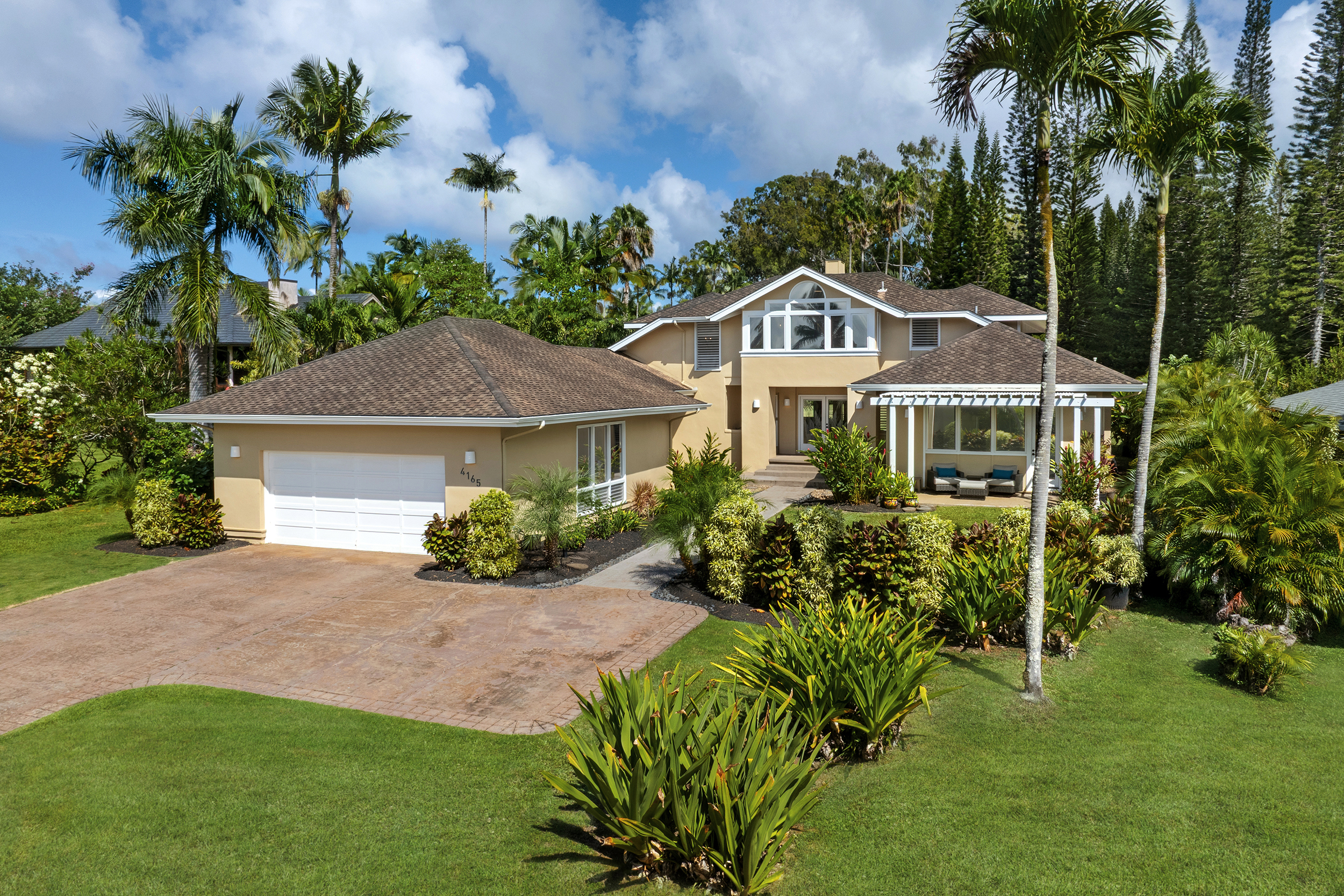 4165 Liholiho Road Princeville, HI 96722 - Photo 25 of 29 a front view of a house with garden