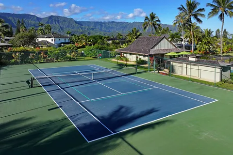 a view of a tennis ground with a large pool