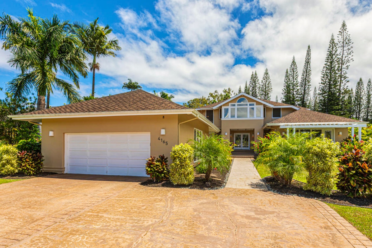 4165 Liholiho Road Princeville, HI 96722 - Photo 3 of 29 a front view of a house with a yard and garage