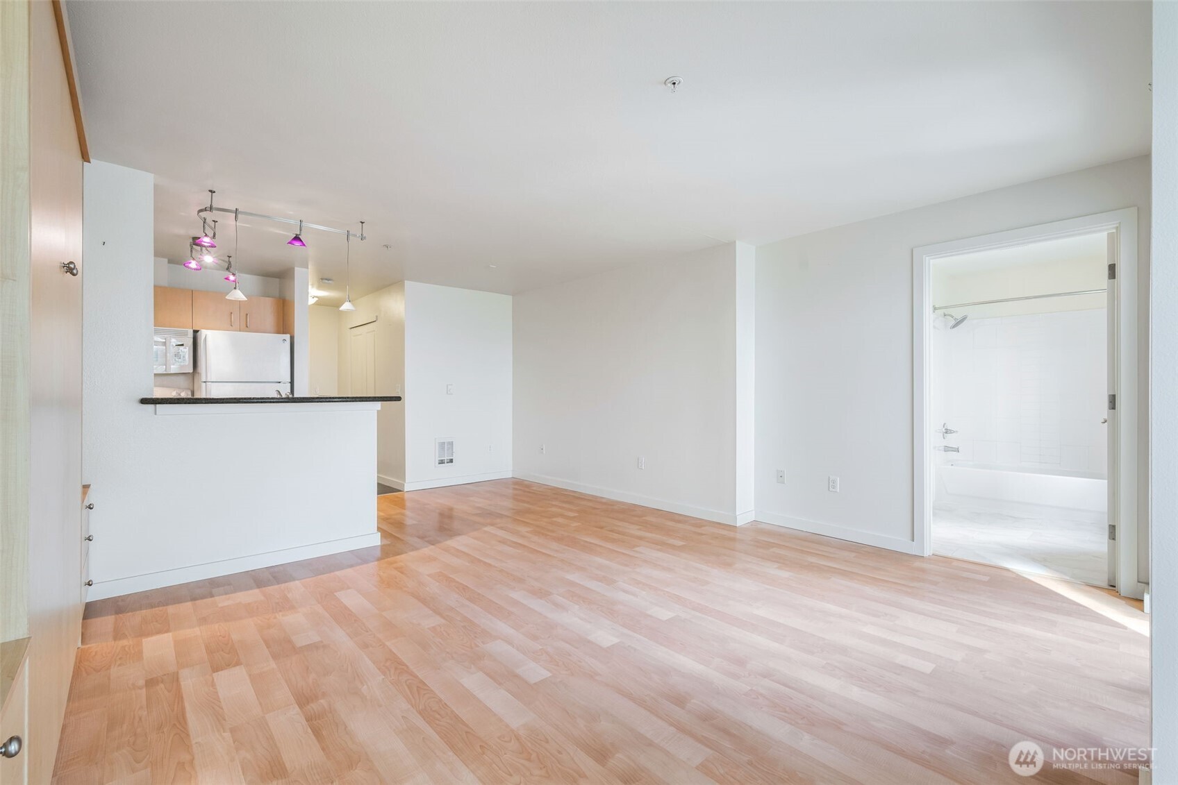 108 5th Avenue South, Unit 720 Seattle, WA 98104 - Photo 13 of 23 a view of empty room with wooden floor