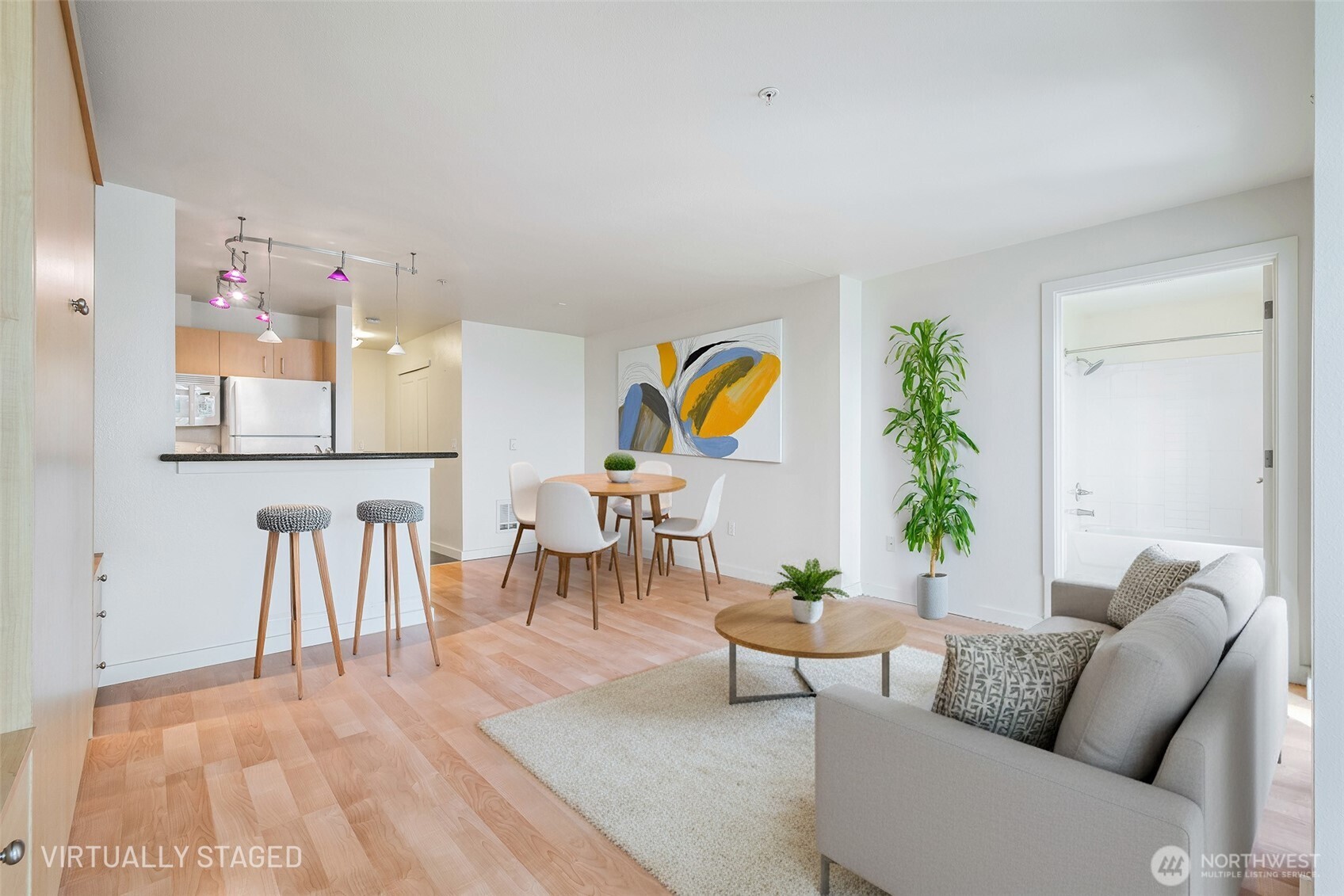 108 5th Avenue South, Unit 720 Seattle, WA 98104 - Photo 14 of 23 a living room with furniture and wooden floor