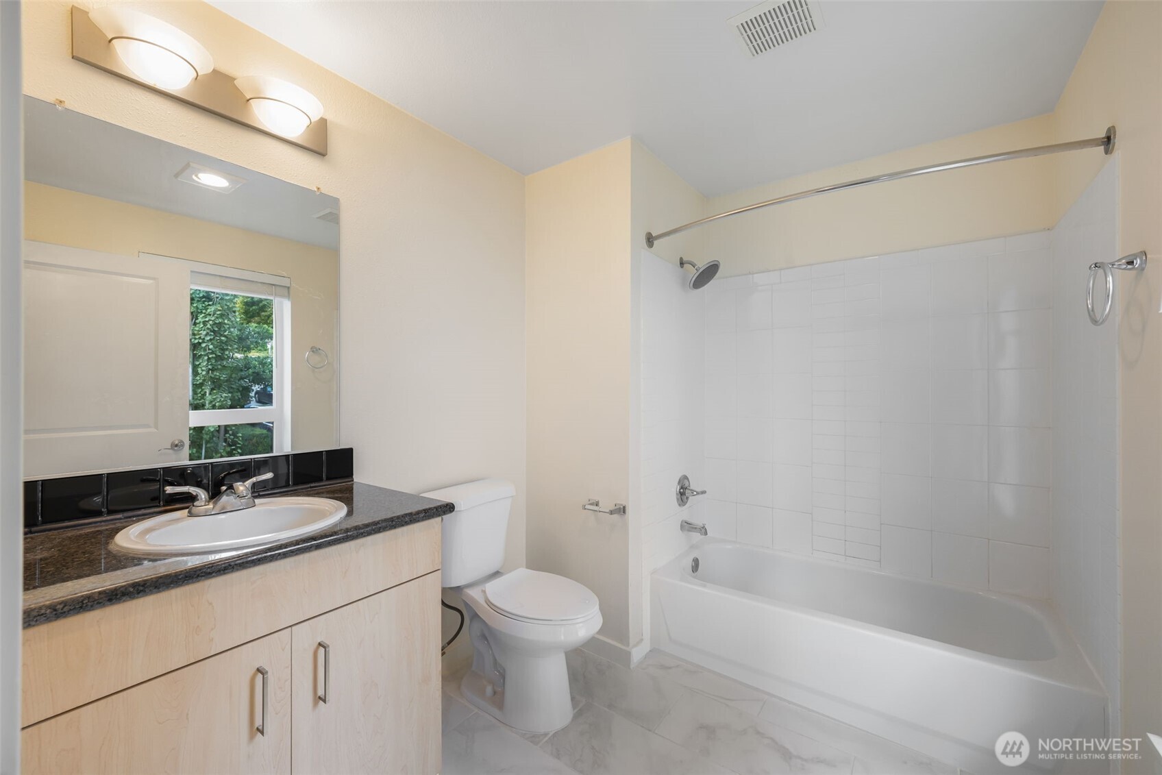 108 5th Avenue South, Unit 720 Seattle, WA 98104 - Photo 20 of 23 a bathroom with a bathtub shower sink vanity mirror and toilet