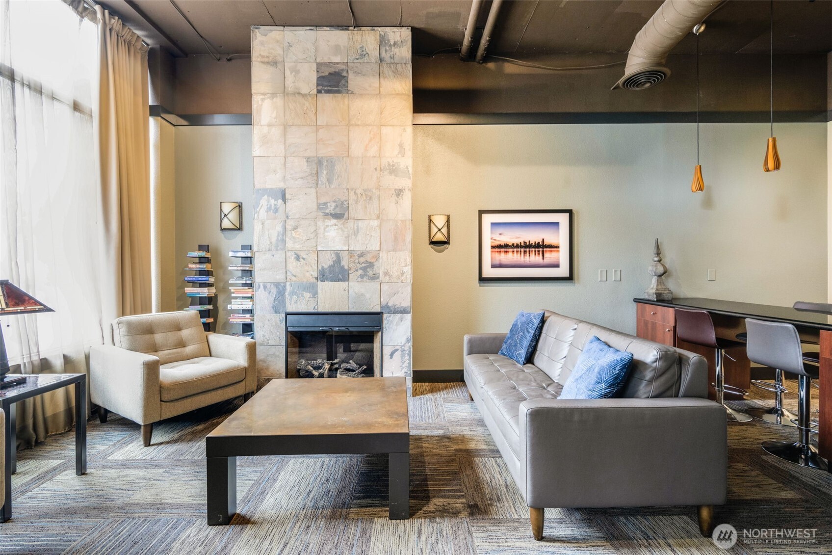 108 5th Avenue South, Unit 720 Seattle, WA 98104 - Photo 2 of 23 a living room with furniture and a fireplace