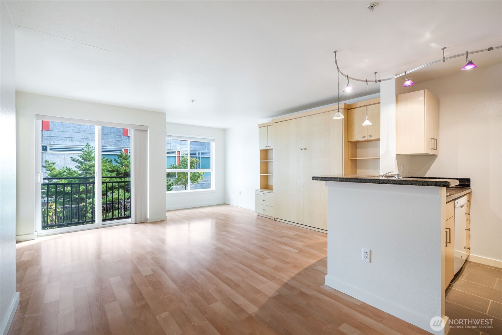 108 5th Avenue South, Unit 720 Seattle, WA 98104 - Photo 5 of 23 a view of a kitchen with wooden floor and a window