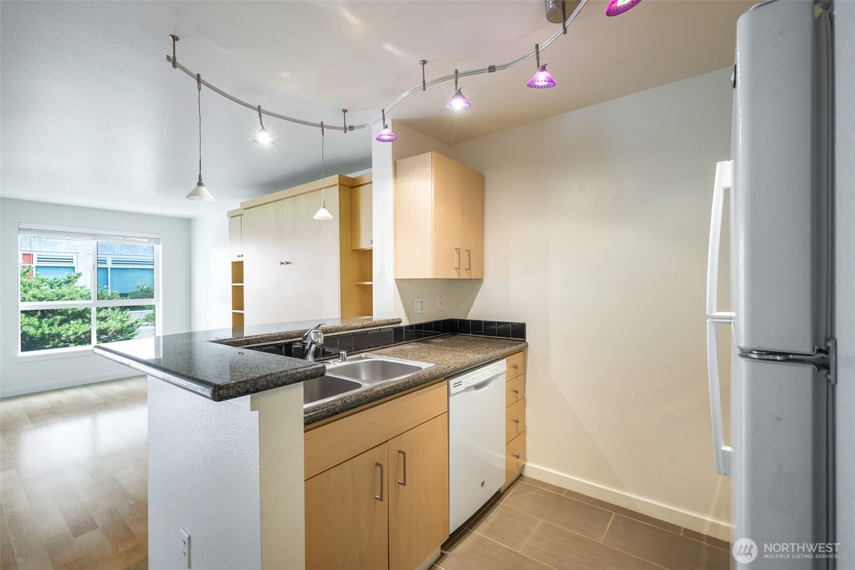 108 5th Avenue South, Unit 720 Seattle, WA 98104 - Photo 6 of 23 a kitchen that has a sink and a stove