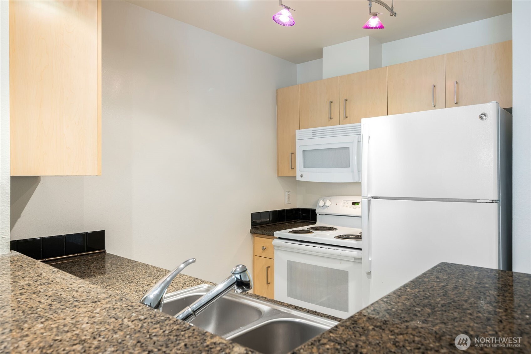 108 5th Avenue South, Unit 720 Seattle, WA 98104 - Photo 7 of 23 a kitchen with a refrigerator stove and sink