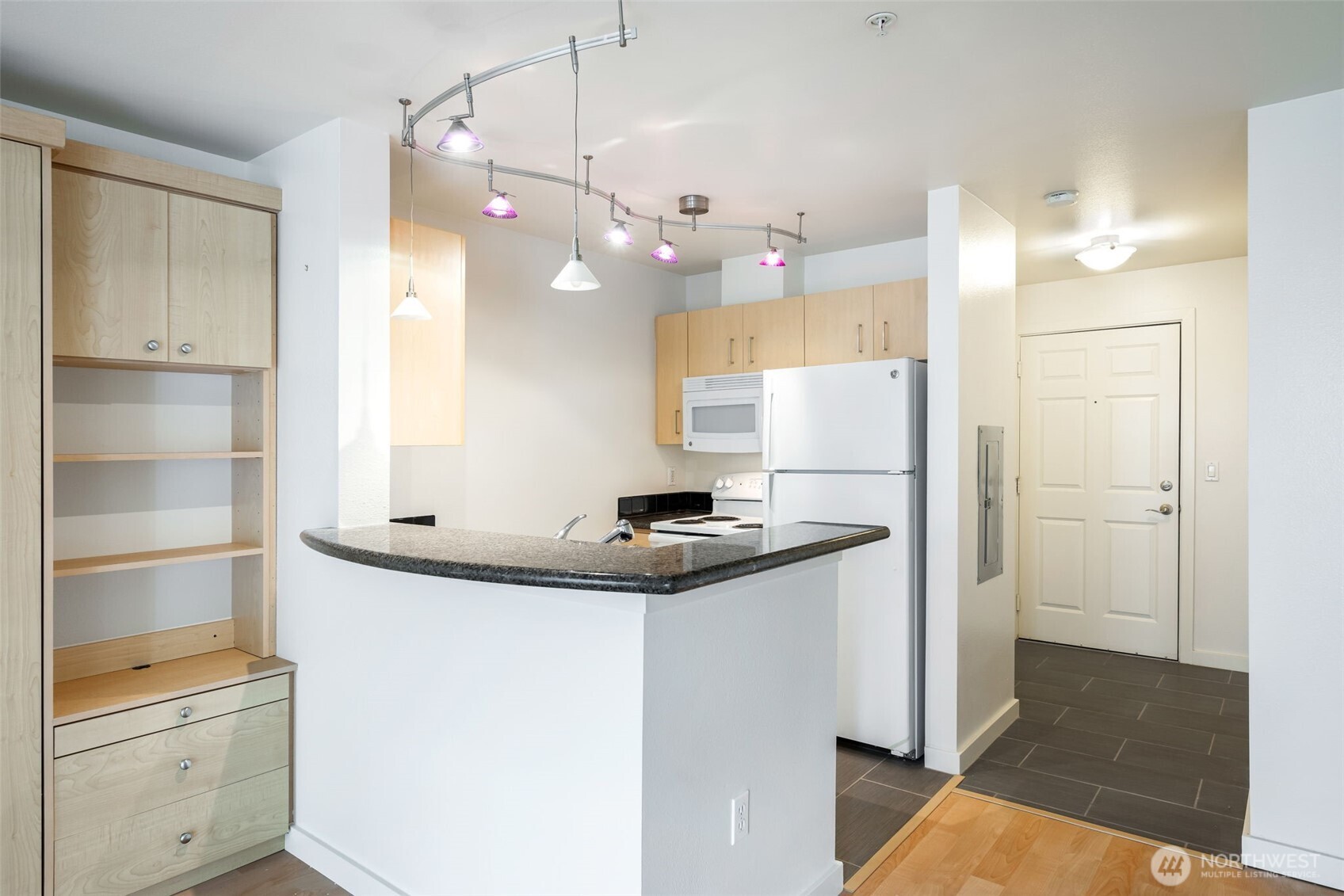 108 5th Avenue South, Unit 720 Seattle, WA 98104 - Photo 8 of 23 a view of a kitchen with a sink and refrigerator