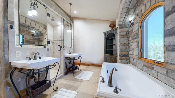 a bathroom with bathtub and shower