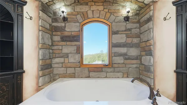 a bedroom with bed and a chandelier