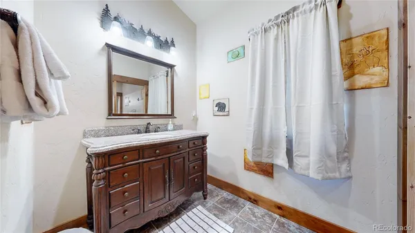 a spacious bathroom with a double vanity sink and a mirror