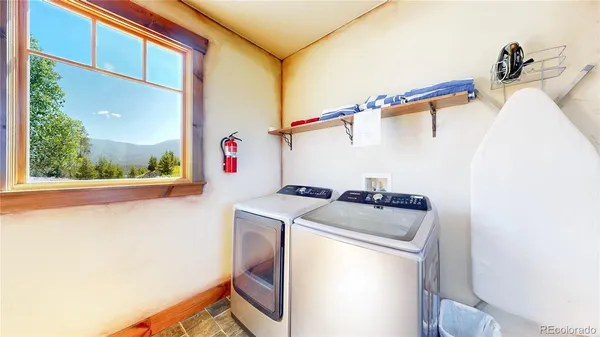 a living room with furniture a flat screen tv and a floor to ceiling window
