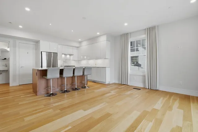 a large kitchen with a table and chairs