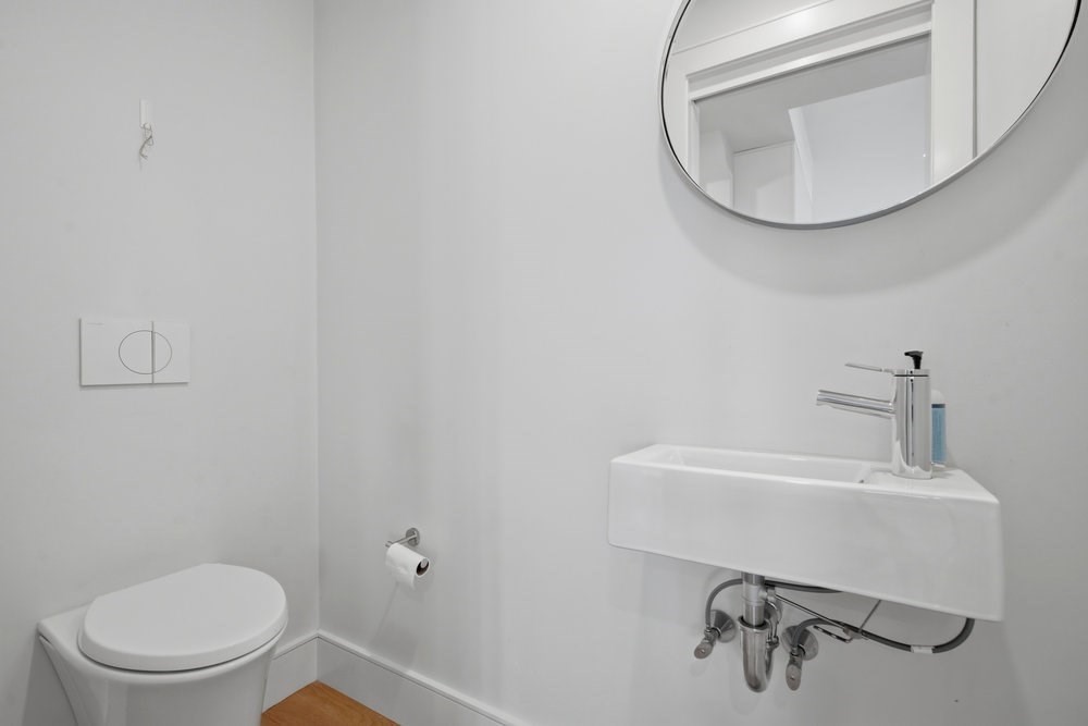 38 Englewood Avenue, Unit 2 Boston, MA 02135 - Photo 11 of 23 a bathroom with a toilet a sink and mirror