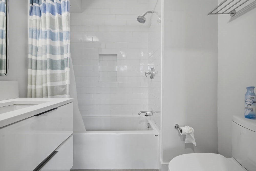 38 Englewood Avenue, Unit 2 Boston, MA 02135 - Photo 15 of 23 a bathroom with a granite countertop sink toilet and shower