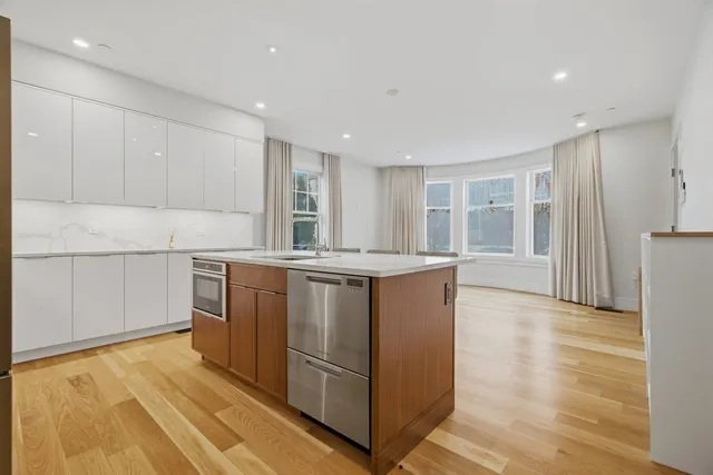 a kitchen with stainless steel appliances granite countertop a refrigerator and a stove