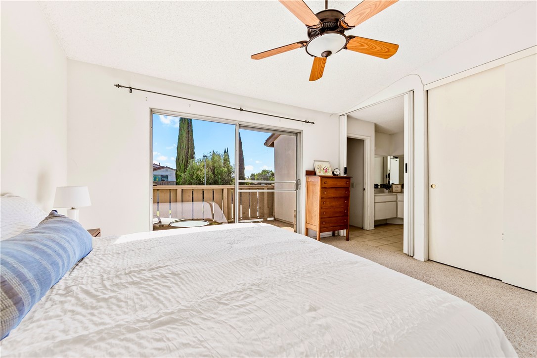 5132 West 1st Street, Unit B Santa Ana, CA 92703 - Photo 19 of 35 a bed room with a bed and a chandelier