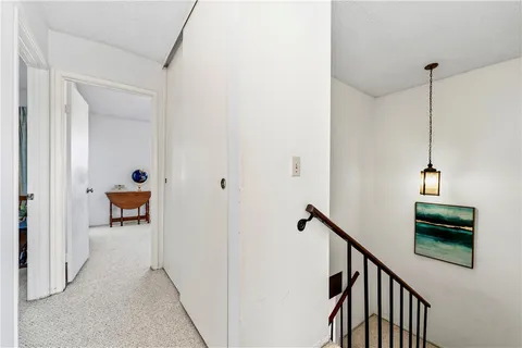 a view of a hallway with dining room and stairs