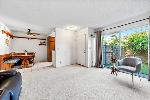 a living room with furniture and a floor to ceiling window