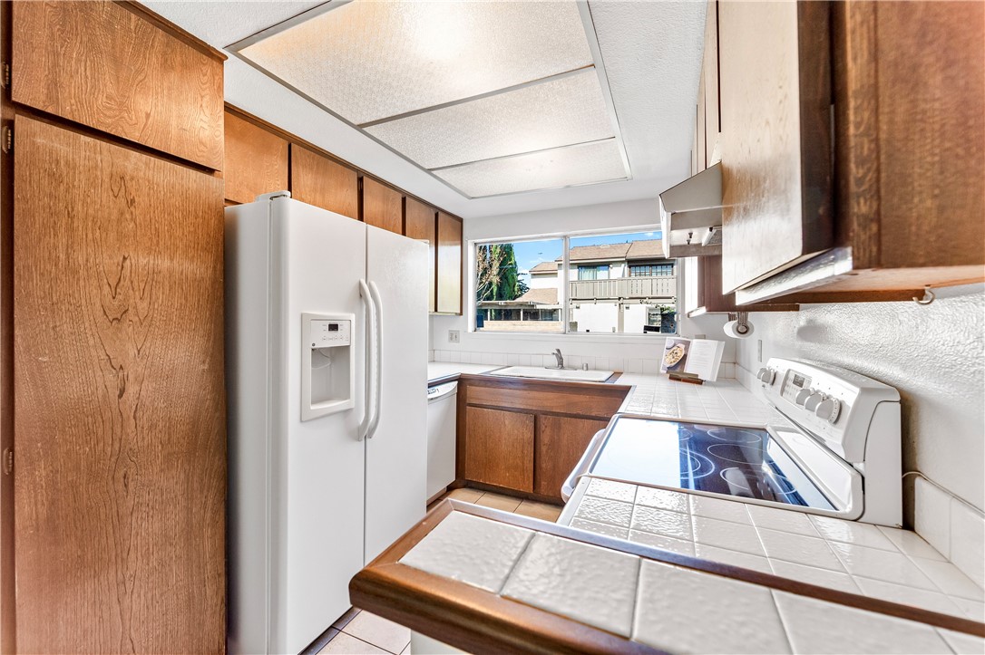 5132 West 1st Street, Unit B Santa Ana, CA 92703 - Photo 9 of 35 a kitchen with stainless steel appliances granite countertop a refrigerator and a stove
