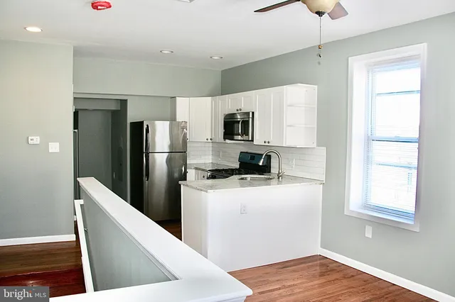a kitchen with stainless steel appliances a refrigerator microwave and stove