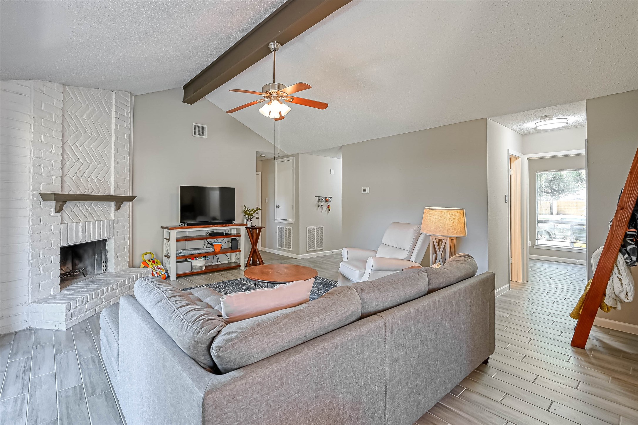 22622 John Rolfe Lane Katy, TX 77449 - Photo 4 of 21 a living room with furniture a fireplace and a flat screen tv