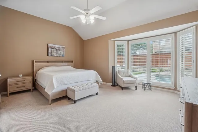 a spacious bedroom with a bed and a couch