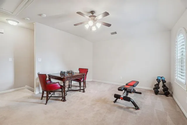 a living room with furniture and a ceiling fan
